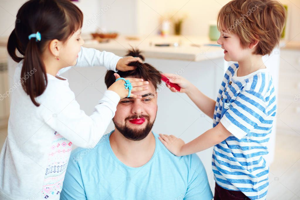 mad kids making crazy hairstyle and makeup to dad at home