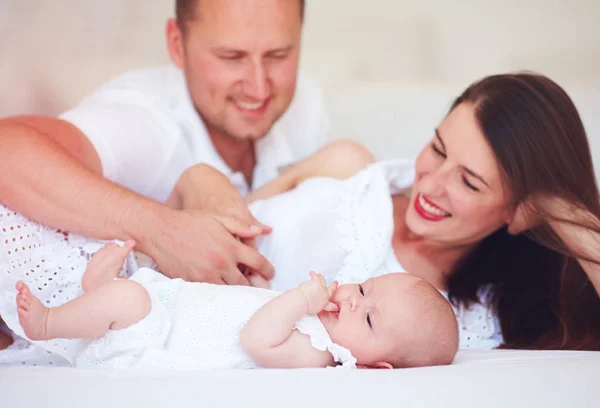 happy young parent enjoying communication with cute infant baby