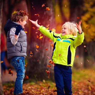 mutlu mutlu okul çocuklar eğleniyor düşmüş atma kadar sonbahar parkta bırakır