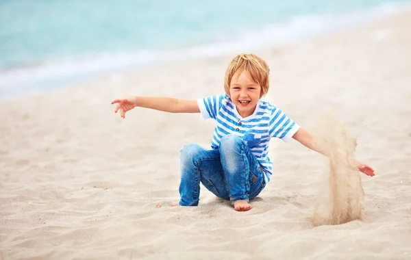 Cute happy laughing boy, kid having fun on sandy beach, summer vacation — Stock Photo, Image