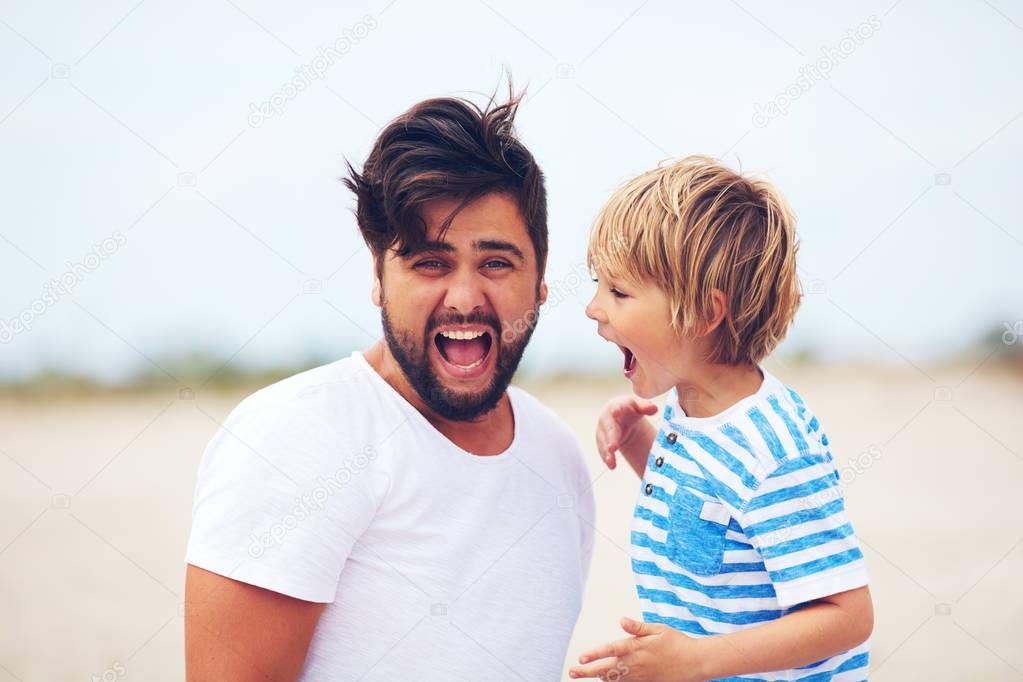 portrait of father and son, kid yelling, making strong sound. people expressions