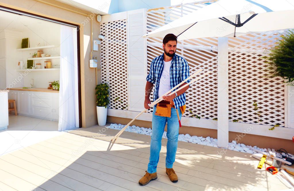 man renovating rooftop patio zone with open space kitchen