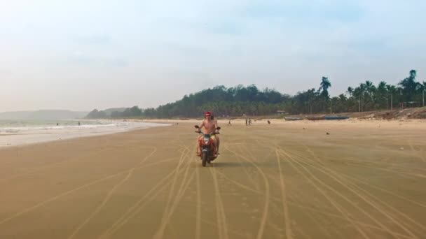 Pareja a caballo motocicleta en la playa cerca del agua — Vídeo de stock