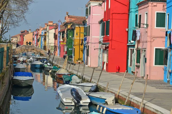 Canal with boats lined with colourful houses