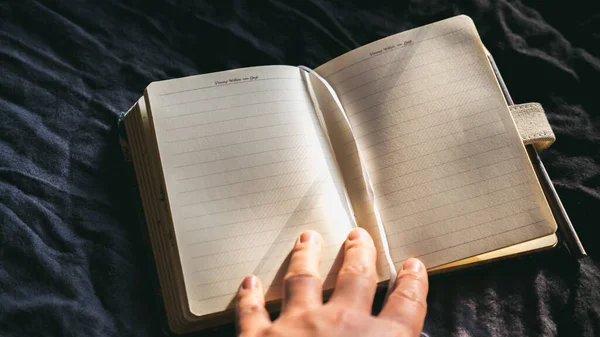 Notepad and pencil, Universal blank opened A4, (A5) magazine with soft realistic shadows on a dark background and yellowish shade, diary, note, blank paper, memo