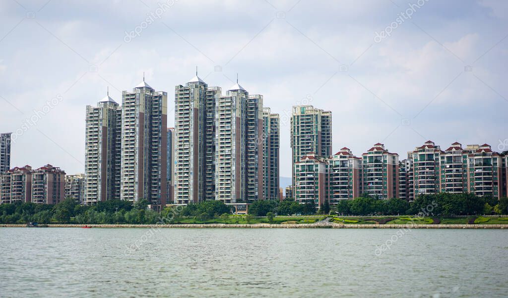 A skyline view of residential apartments and buildings in China, modern architecture, skyscrapers, a typical Chinese city, clear weather without pollution, blue sky and fresh air 