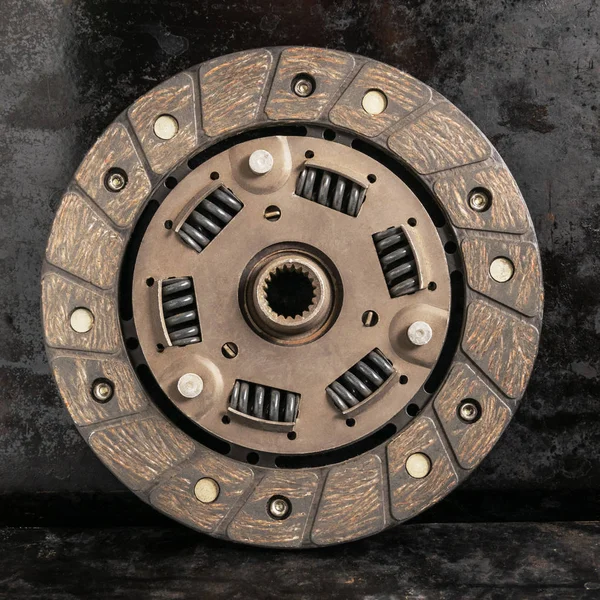 Clutch disc on a dark background. Car transmission detail