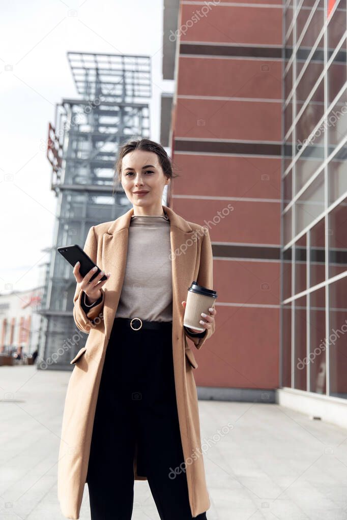 Young Businesswoman Smiling While Using a Mobile Phone