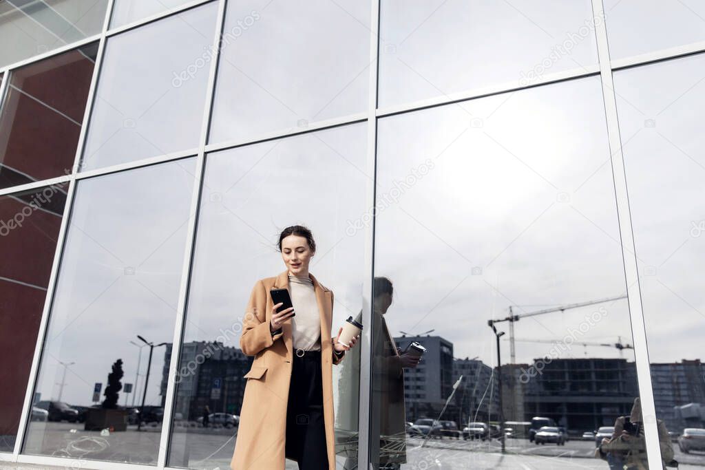 Young Businesswoman Smiling While Using a Mobile Phone