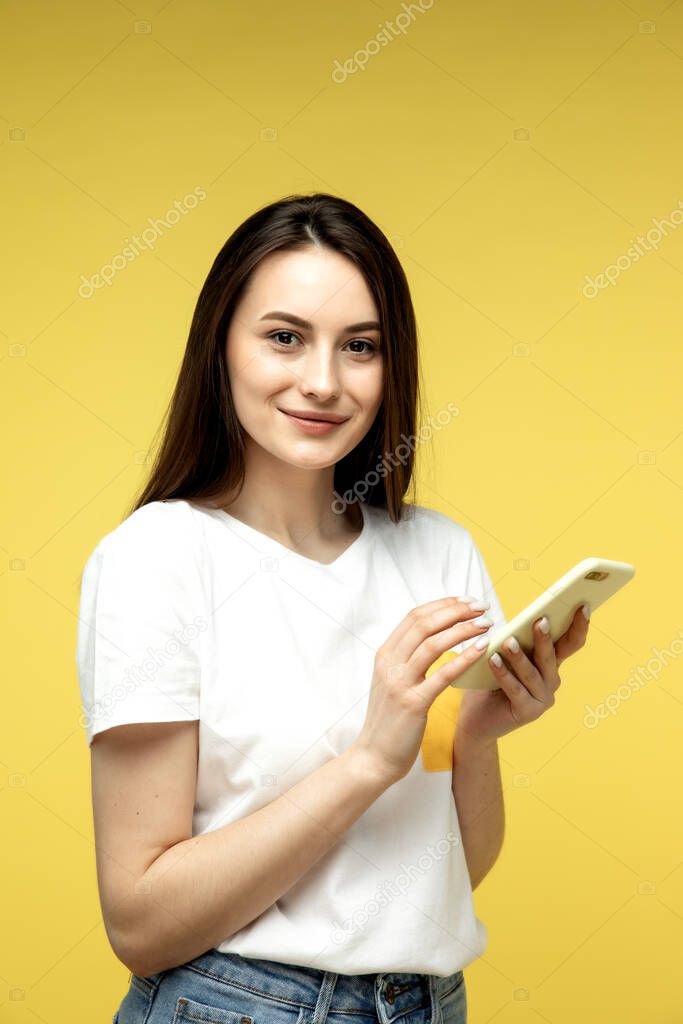 Surprised business women with laptop on yellow background.