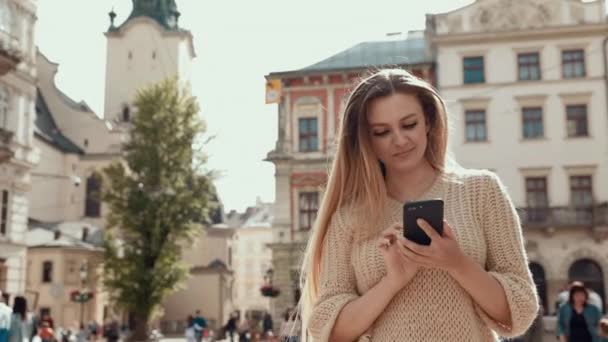 Experienced female lawyer with leather briefcase sitting at public urbanity with modern cellphone device in hand and making online booking during ticketing on website with business flights — Stock Video