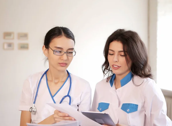 Two doctors with paper documents