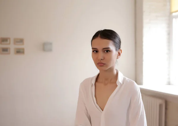 Portrait young woman sitting in the house