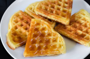 Taze ev yapımı kalp şeklinde waffle 'lar beyaz tabakta.