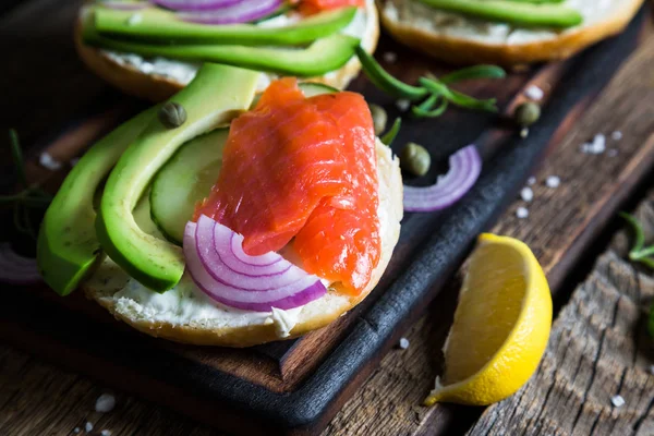 Bagels con queso crema, salmón ahumado y aguacate — Foto de Stock