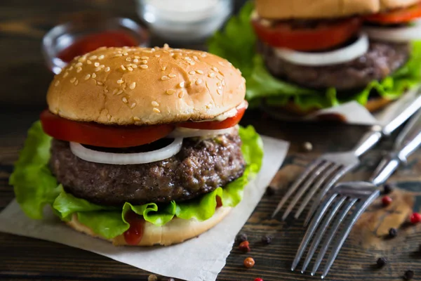 Hamburgers on a wooden table — Stock Photo, Image