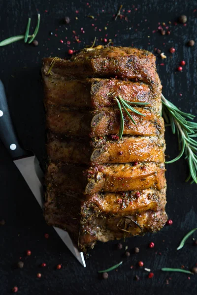 Pork loin on bone baked with herbs — Stock Photo, Image
