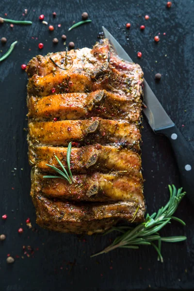 Pork loin on bone baked with herbs — Stock Photo, Image