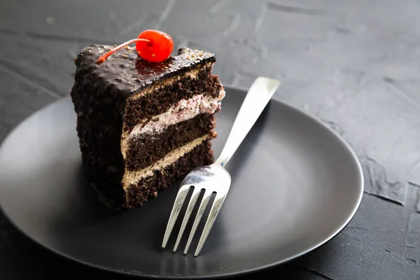 A piece of chocolate cake with cherries — Stock Photo, Image