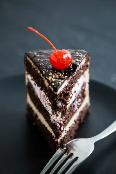 A piece of chocolate cake with cherries — Stock Photo, Image