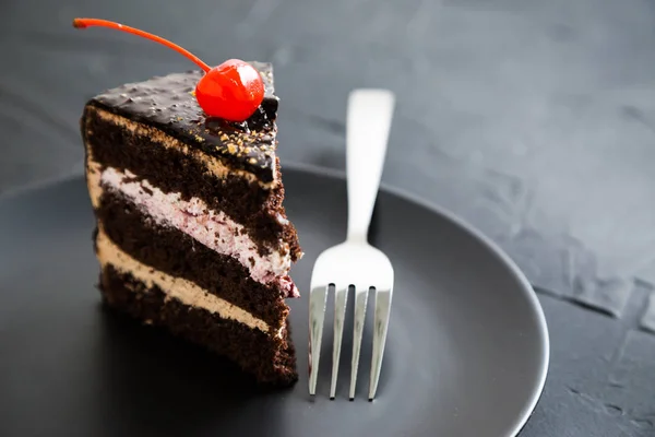 A piece of chocolate cake with cherries — Stock Photo, Image