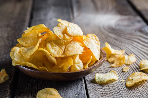 Potato chips on a wooden table