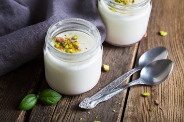 Natural yogurt in a glass jar clipart