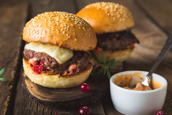 Big burger with cheese and cranberry sauce