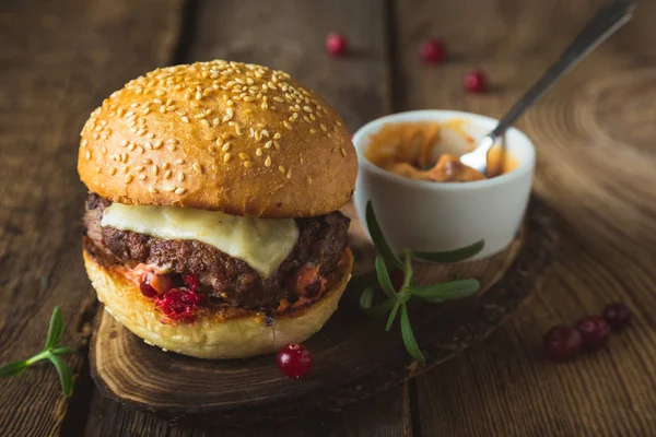 Big burger with cheese and cranberry sauce