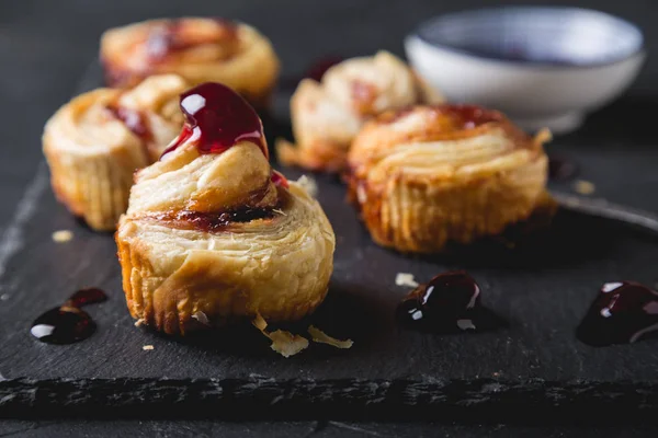 Small puff pastry rolls with cherry jam