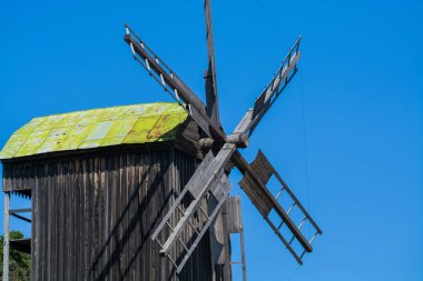 24.08.2019. Kyiv, Pirogovo-house, Ukraine.  Old wooden mills with green roofs from different parts of Ukraine. Historical heritage.
