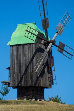 24.08.2019. Kyiv, Pirogovo-house, Ukraine.  Old wooden mills with green roofs from different parts of Ukraine. Historical heritage.