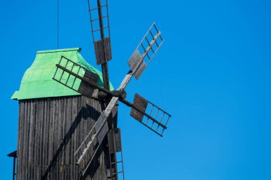 24.08.2019. Kyiv, Pirogovo-house, Ukraine.  Old wooden mills with green roofs from different parts of Ukraine. Historical heritage.