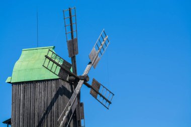 24.08.2019. Kyiv, Pirogovo-house, Ukraine.  Old wooden mills with green roofs from different parts of Ukraine. Historical heritage.