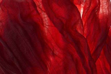 Kırmızı kehribar, elek, pamuk kumaş ve kumaşın arka planı veya dokusu.