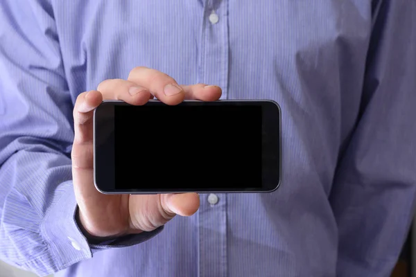 Joven hombre sosteniendo el teléfono —  Fotos de Stock