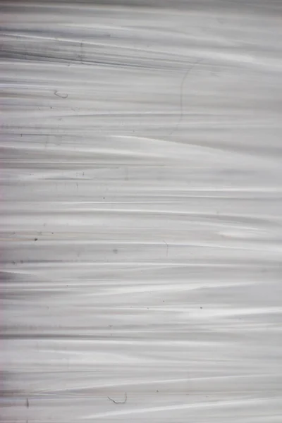 White wires, plastic coil in macro. Close-up of a strip of plastic in a coil of transparent color.