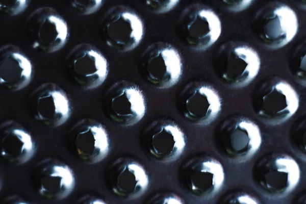 Closeup of a kitchen grater. Kitchen grater close-up, pattern