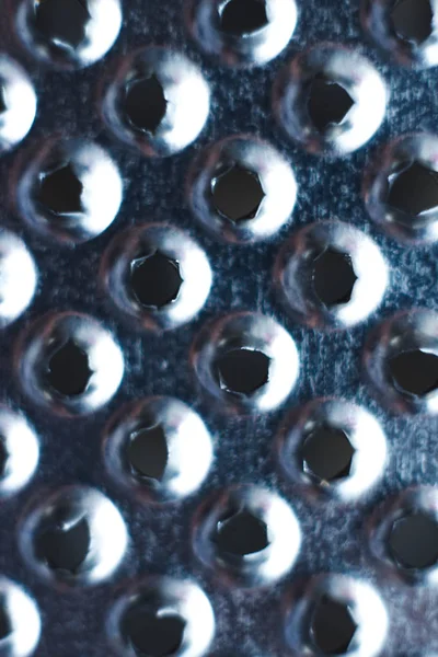 Closeup of a kitchen grater. Kitchen grater close-up, pattern