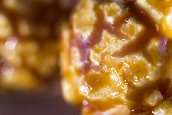 Closeup of popcorn in caramel. Popcorn with brown caramel in the cracks