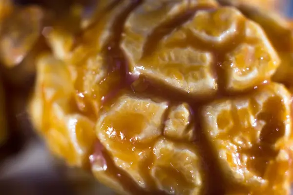 Closeup of popcorn in caramel. Popcorn with brown caramel in the cracks