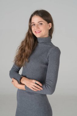 Beyaz arka planda kendini yalnız hissedip kollarını kavuşturan güzel, beyaz bir kadının Protrait çekimi..