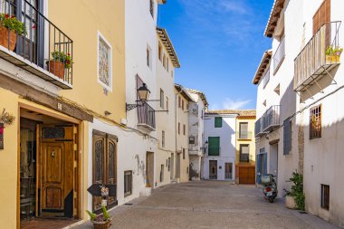 Typical colorful old Spanish houses with small balconies on Calle Castillo Requena, Spain