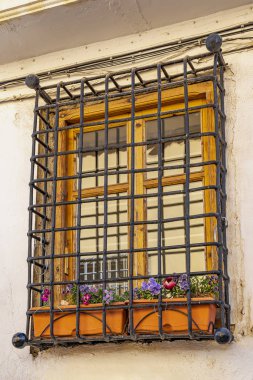 Metal frames and flower boxes in the windows of the old houses in Requena, Spain