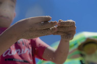 Yazın çocuklar eğlenmeyi ve kumsalda kumdan kaleler yapmayı severler.