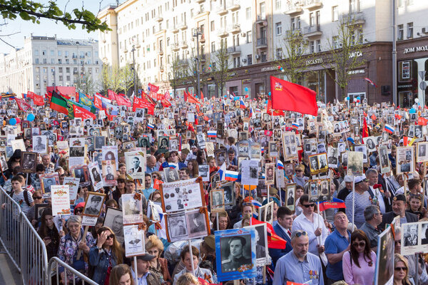 Moscow, Russia - May 9, 2018: Immortal Regiment procession in Victory Day - thousands of people marching toward the Red Square and Kremlin in memory of the participants of the World War Two