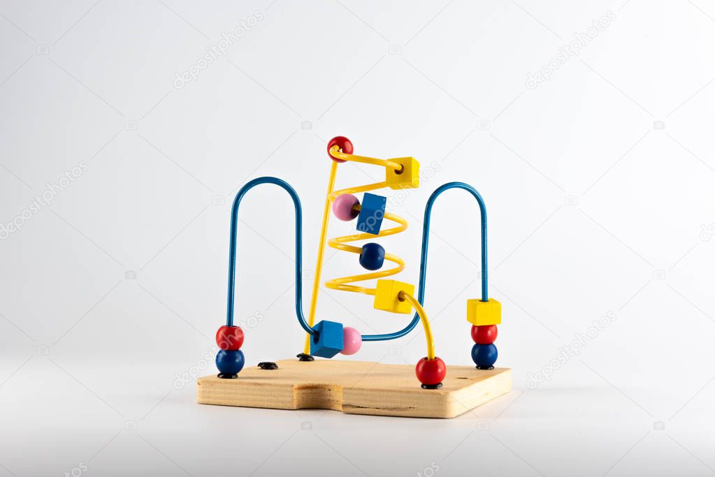 A small child's development toy with wires and charms 