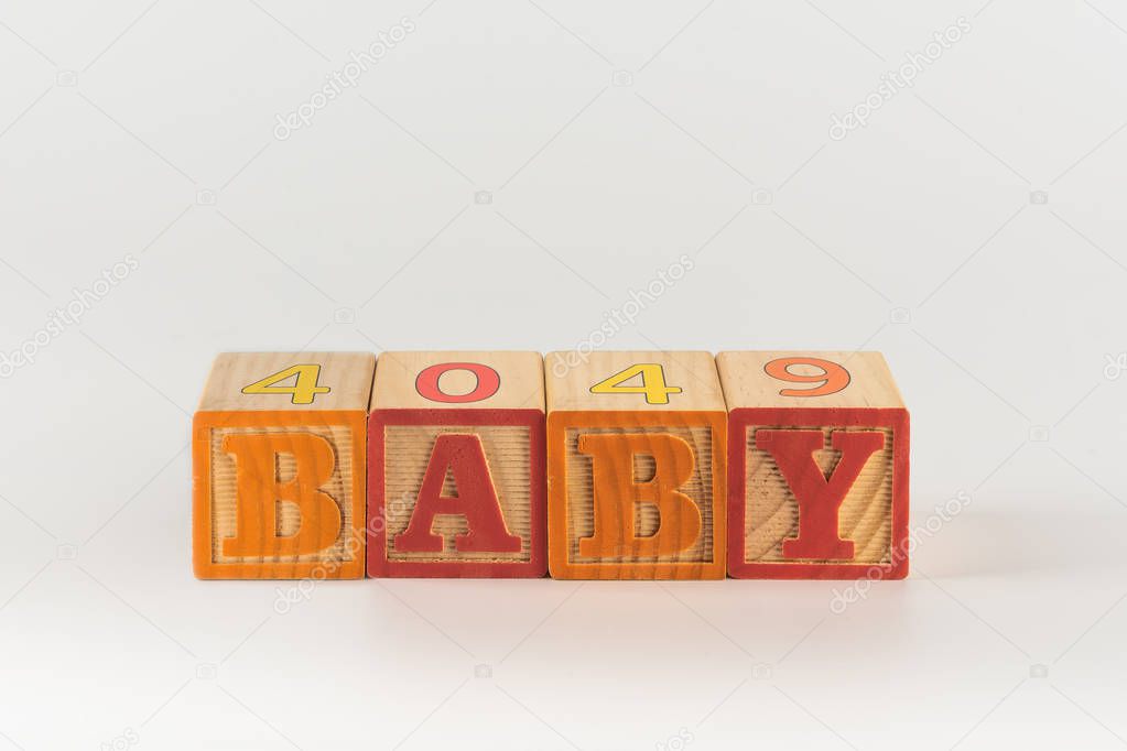 A child's alphabet toy spelling word block set, spelling out the word baby
