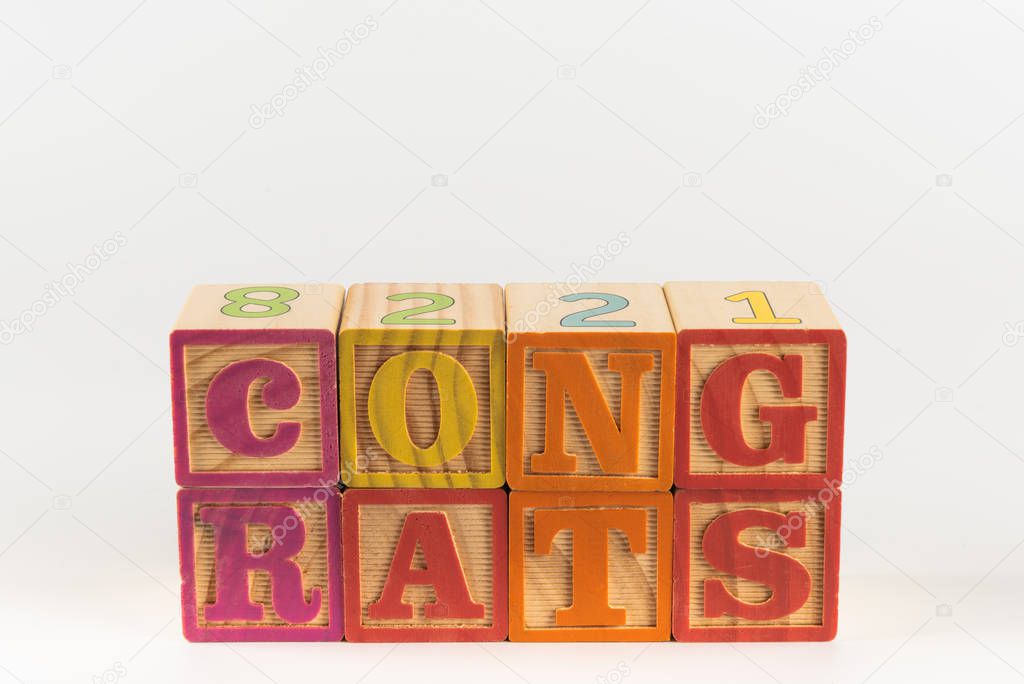 A child's alphabet toy spelling word block set, spelling out the word congrats