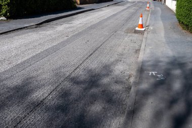 A road surface which has been taken back to a lower laminate level preparing it for resurfacing. clipart